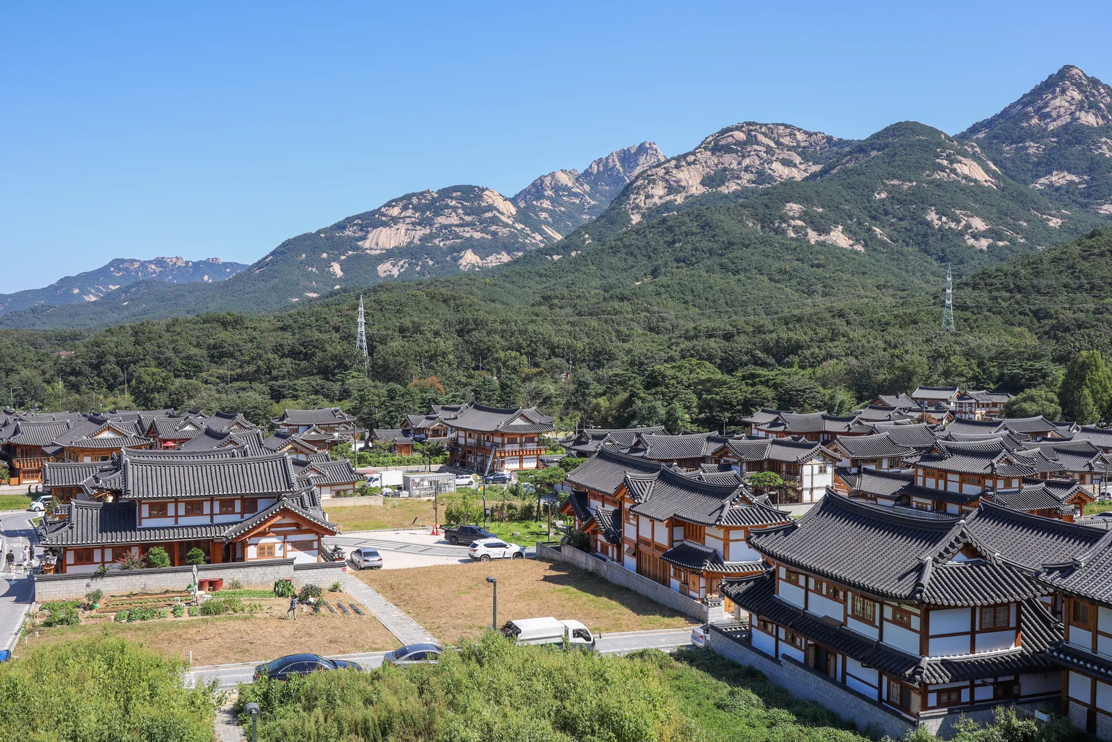 The tiled roofs of Eunpyeong Hanok Village with the Bukhansan ridge behind
