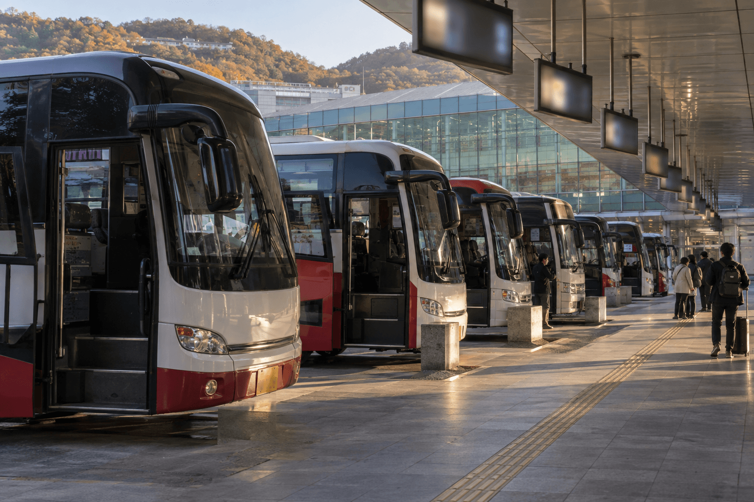 Buses lined up in the boarding lanes of an express bus terminal
