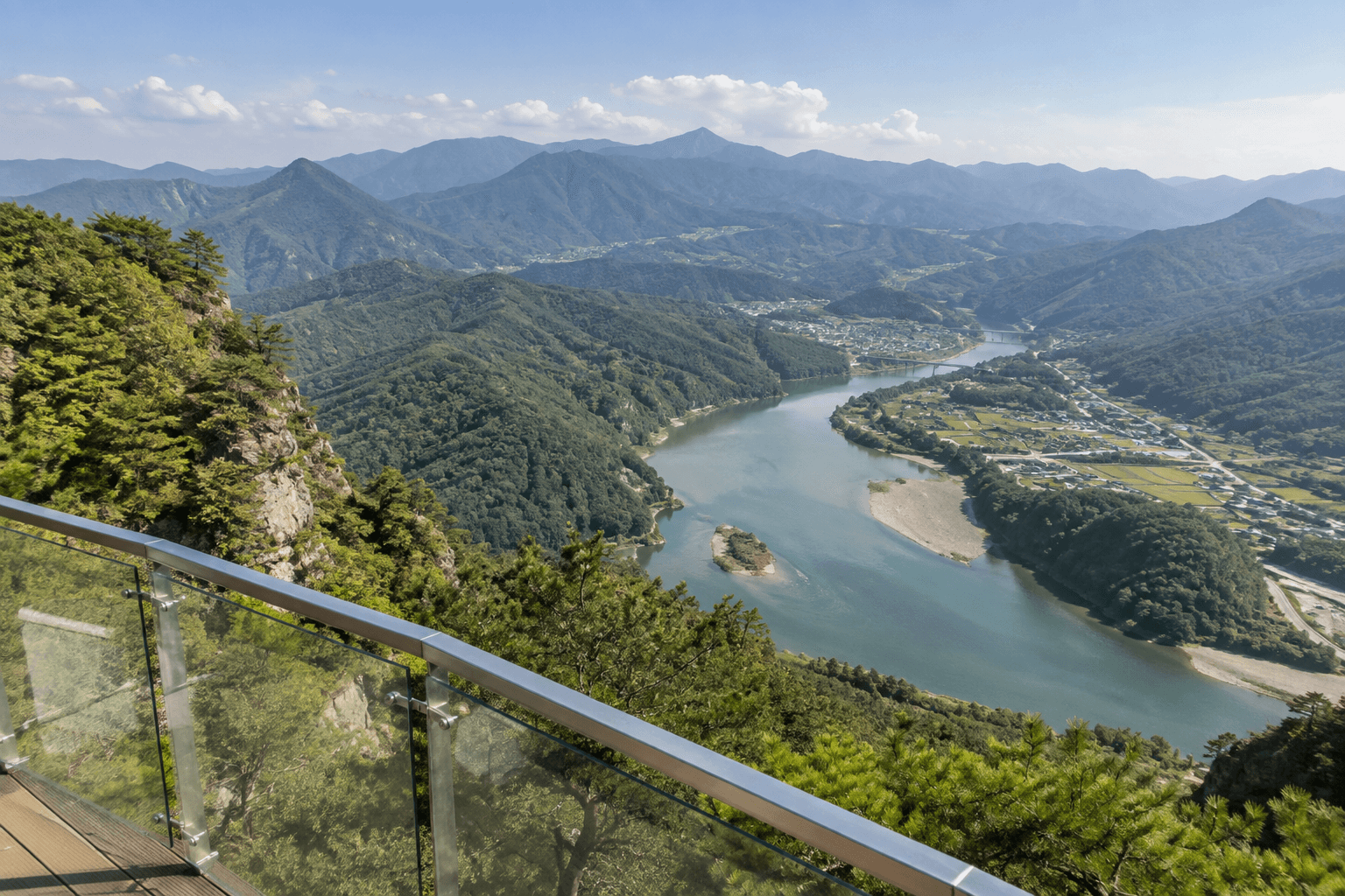 An example image of the river and ridgelines seen from the glass viewpoint of Mancheonha Skywalk