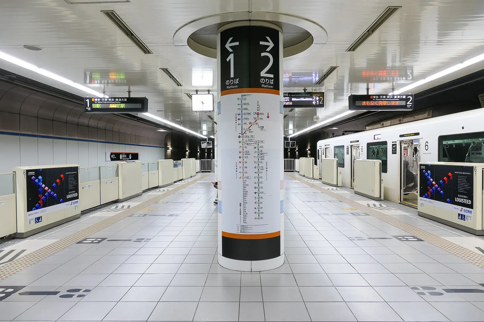The underground platform at Fukuoka Airport Station, with a pillar marked for platforms 1 and 2