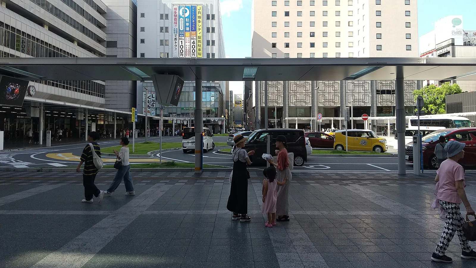 The square outside Hakata Station's Chikushi Exit, with a long canopy over the taxi and bus area