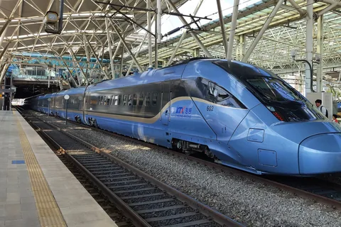 A pale blue KTX-Cheongryong train waiting at a platform under the steel roof of Seoul Station