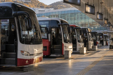 Buses lined up in the boarding lanes of an express bus terminal