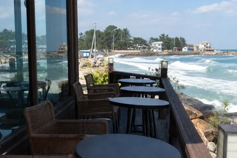 An outdoor café deck beside the sea