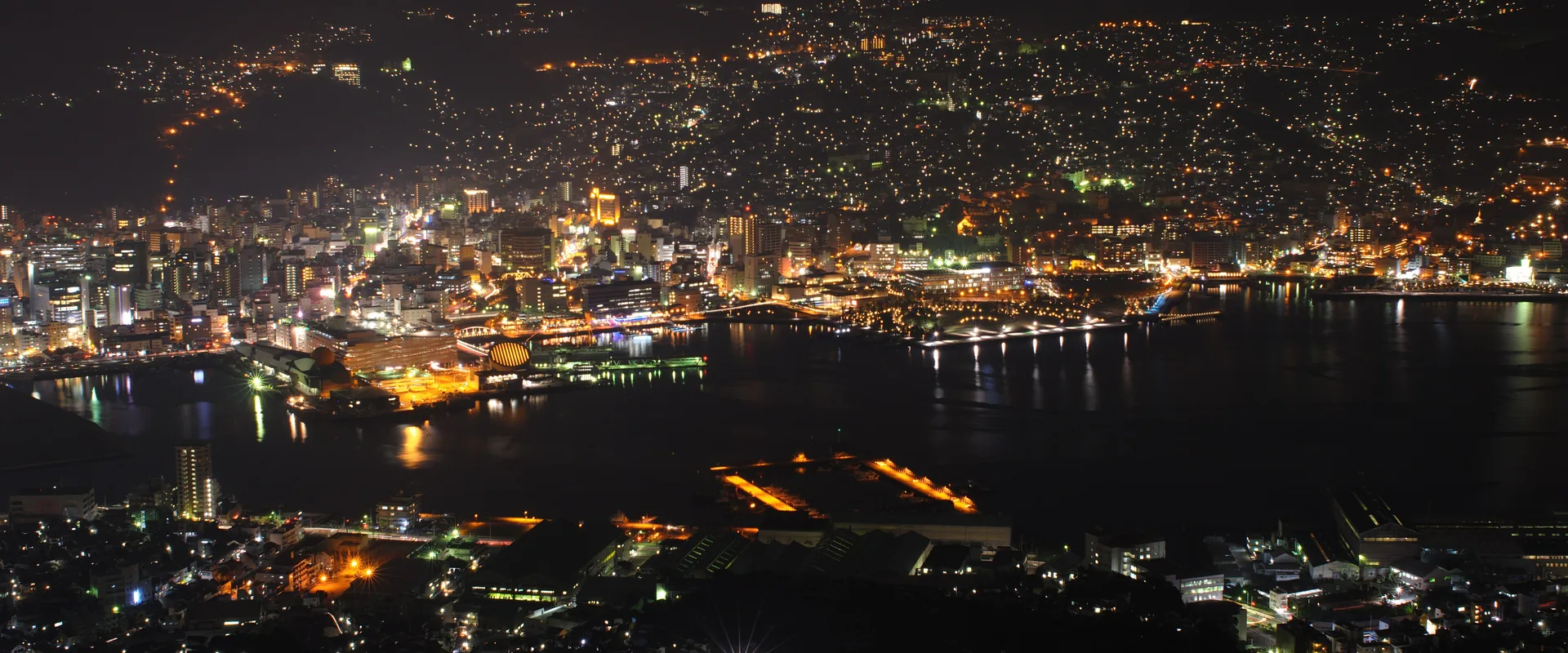 Nagasaki's harbour and city lights at night, seen from Mount Inasa