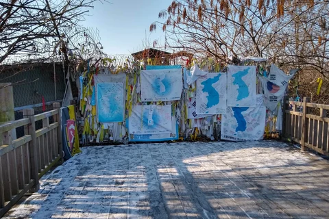 Wooden deck at Imjingak Freedom Bridge, with reunification banners tied to a fence in winter
