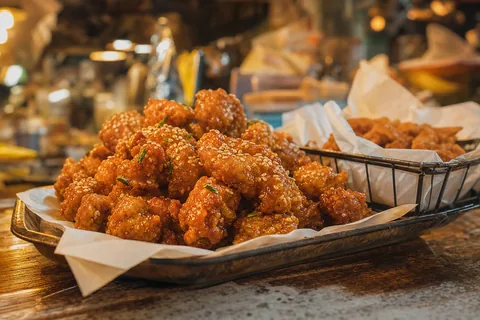 Glazed fried chicken with sesame in a tray