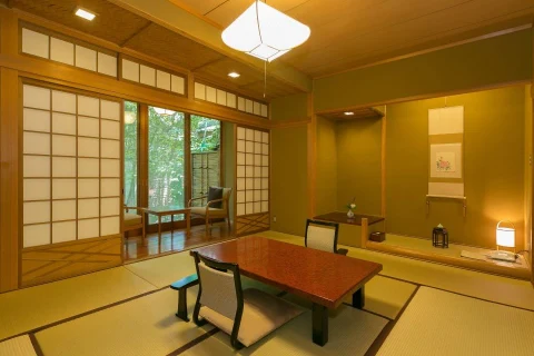 A tatami room with a low table and window seating at Hinoharu