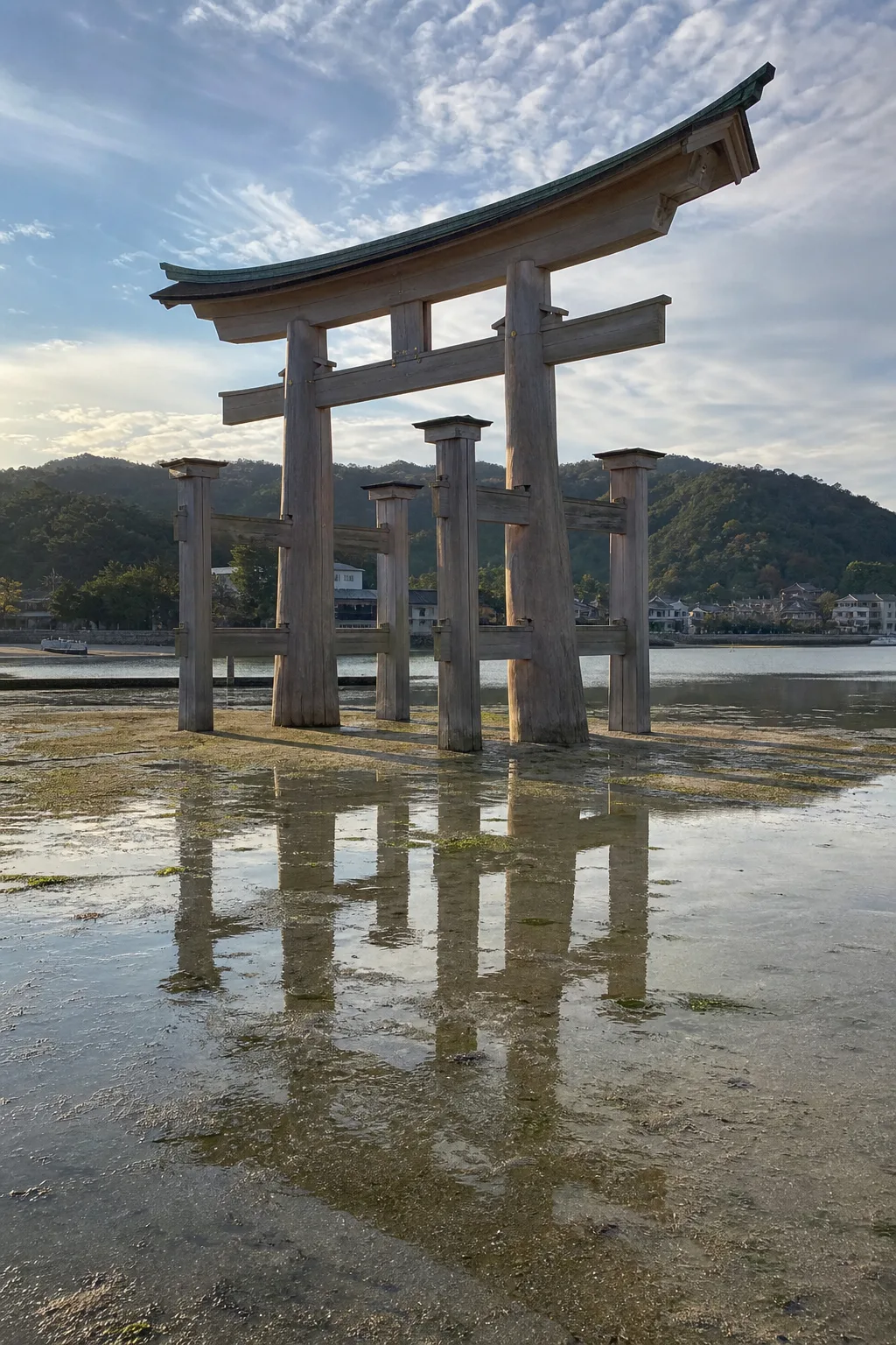 The great torii of Itsukushima Shrine standing on exposed sand at low tide