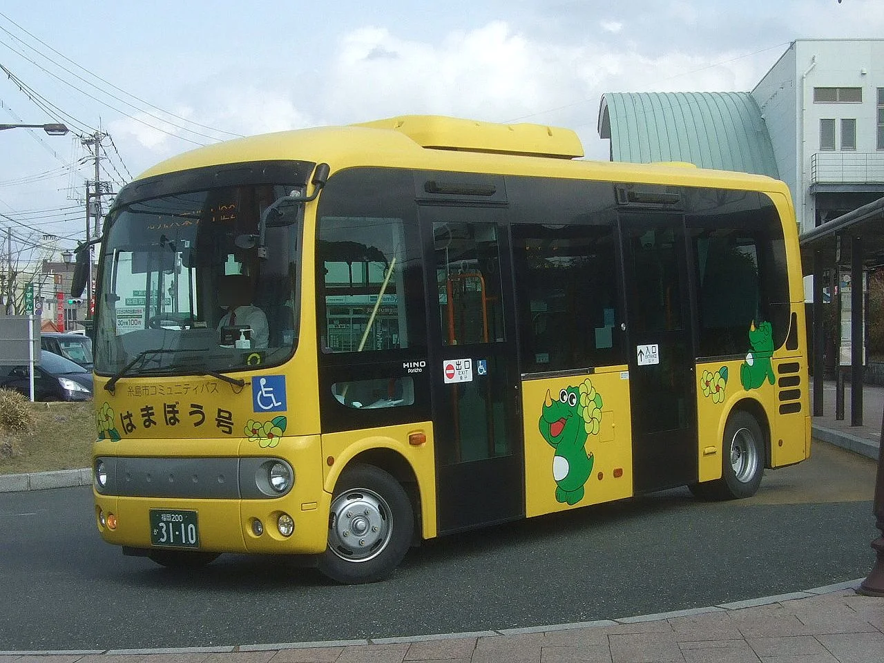 A small yellow Itoshima City community bus at a stop