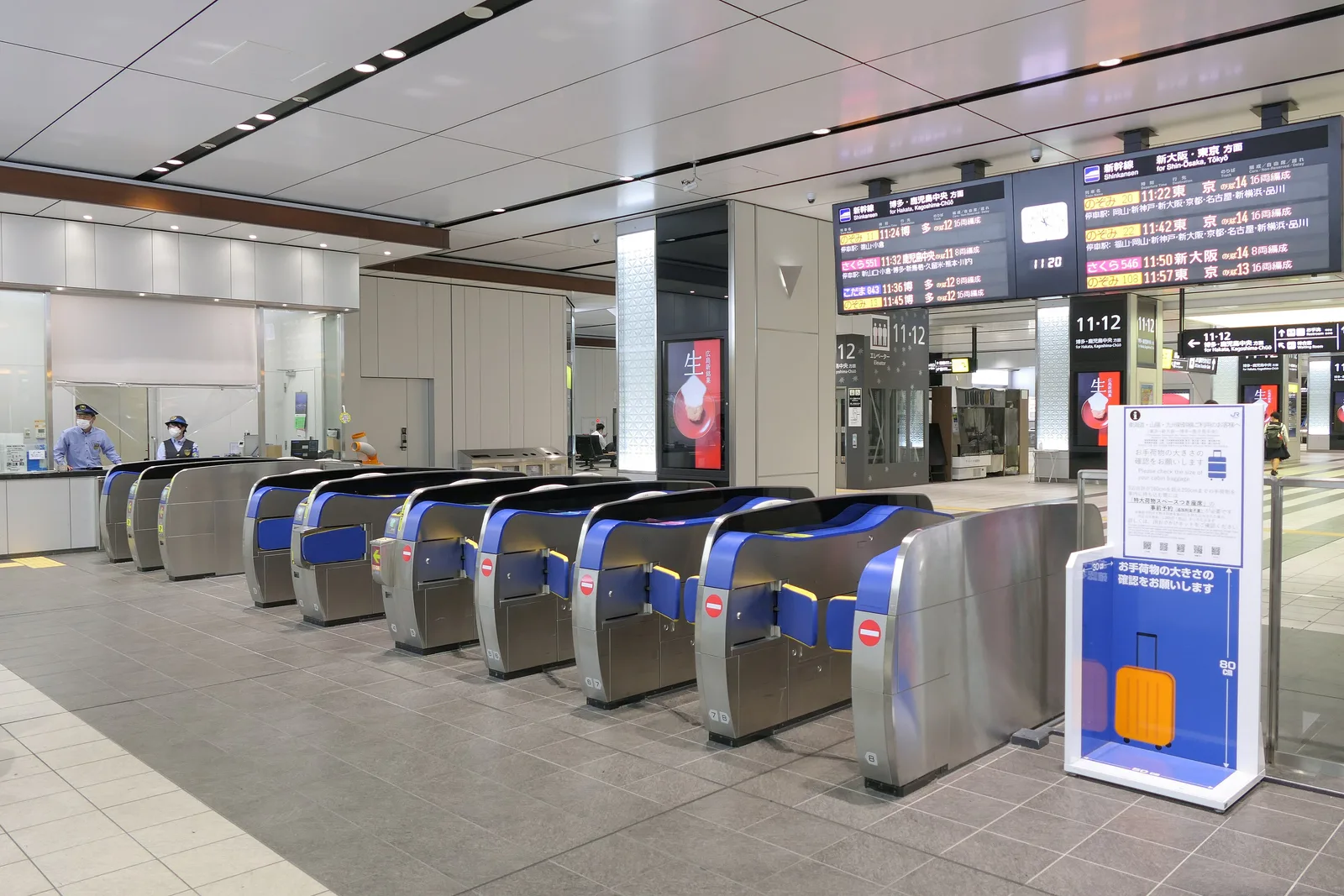 Shinkansen ticket gates at Hiroshima Station with departure boards above