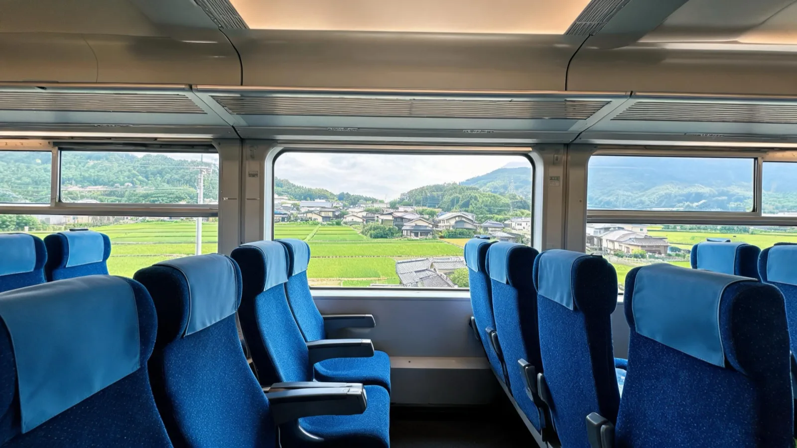 A traveler looking out the window from a non-reserved seat