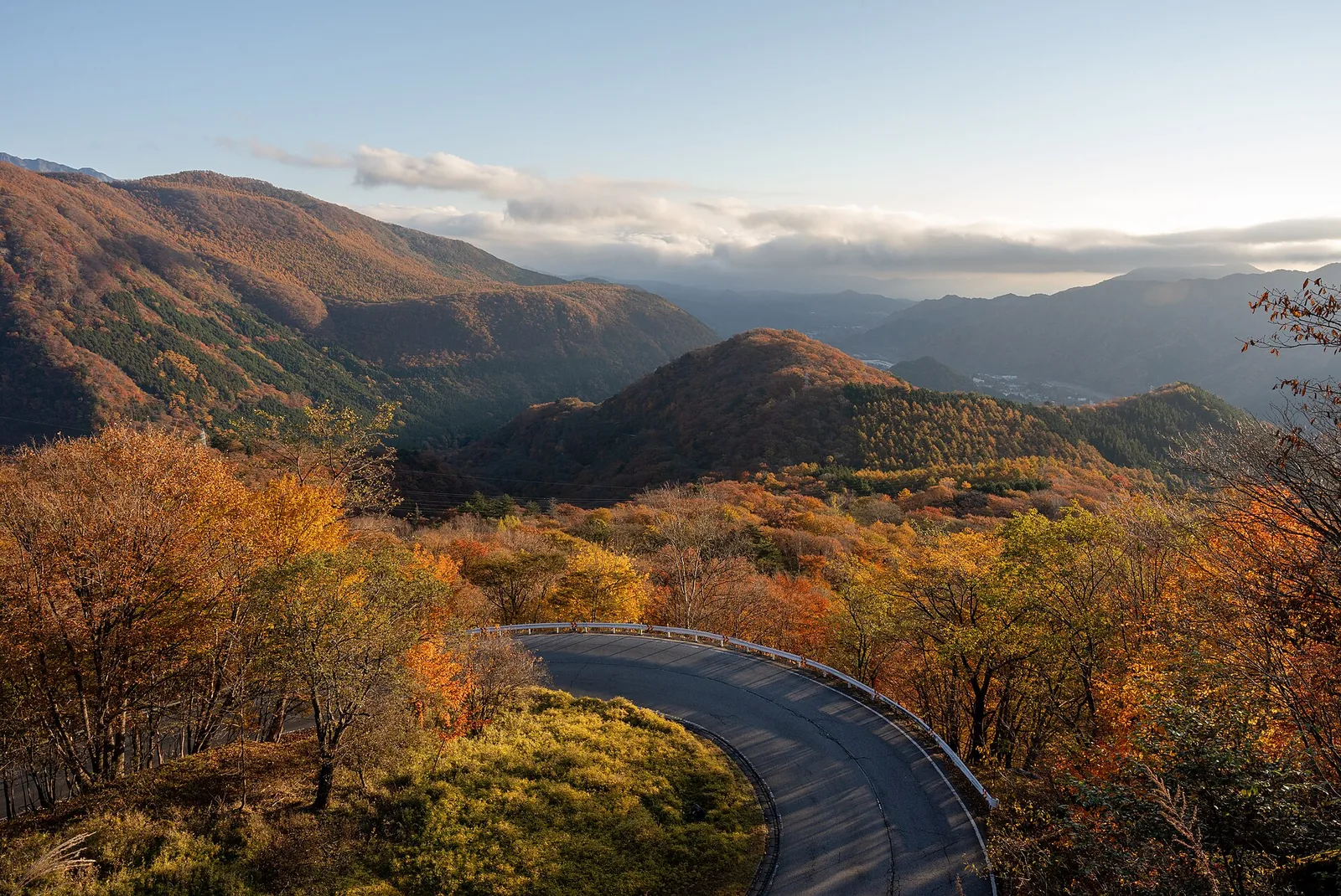 The Irohazaka road near Nikko curving down between autumn-colored mountain slopes