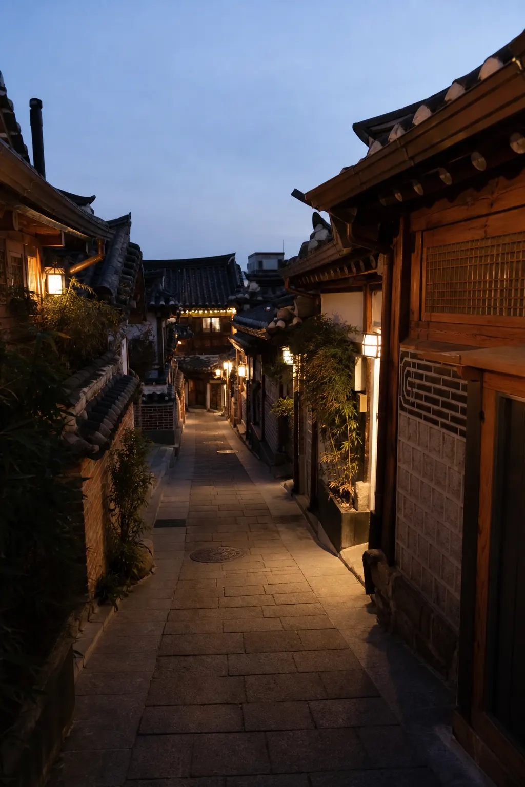 A narrow lane between traditional tiled-roof buildings at dusk