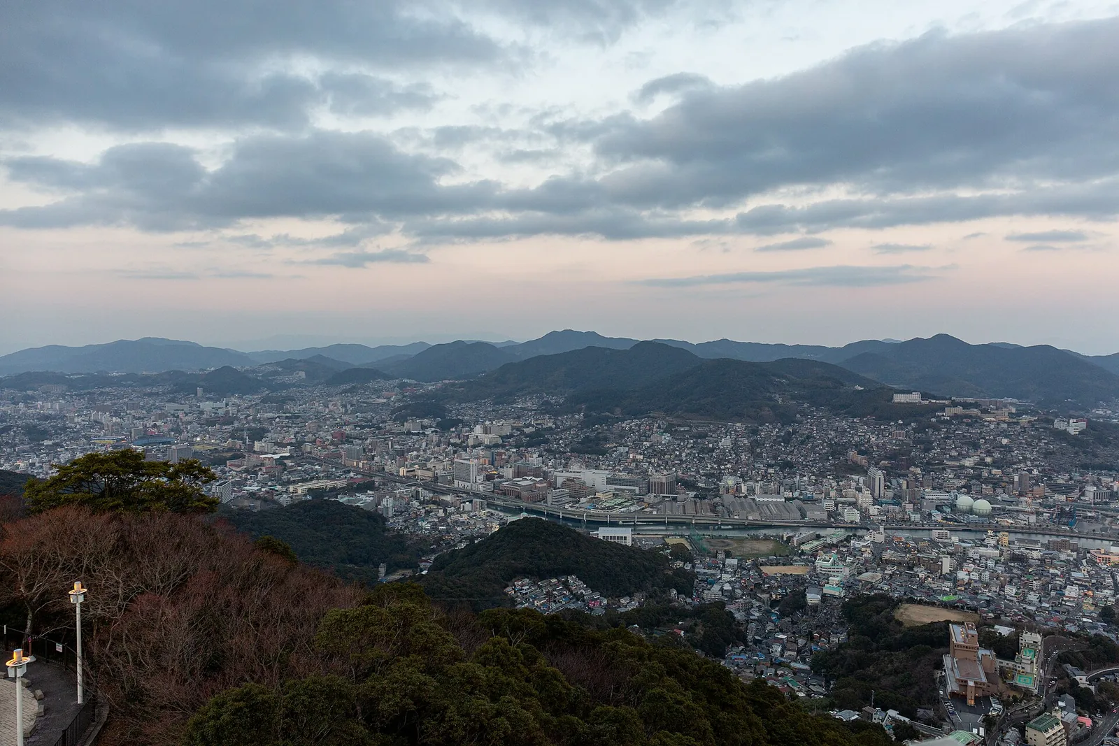 Nagasaki city and the hills beyond at dusk, seen from the Mount Inasa observation deck